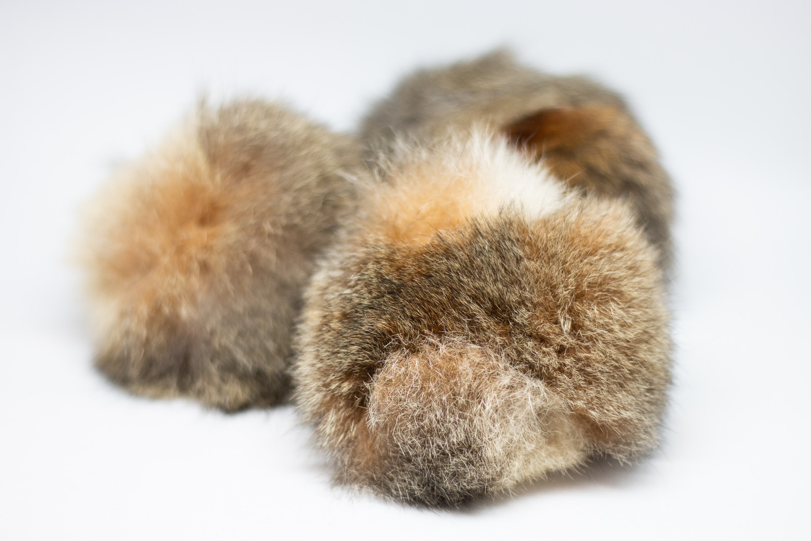 Soft, hand-woven cultural objects in natural fur and fibre, used in a Mangrook workshop.