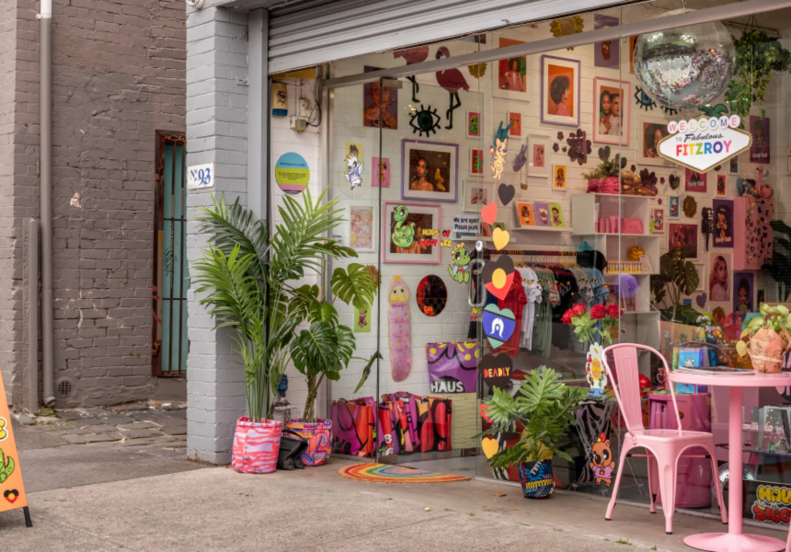 Haus of Dizzy shopfront in Fitzroy, window filled with artwork, jewellery and pink furniture.