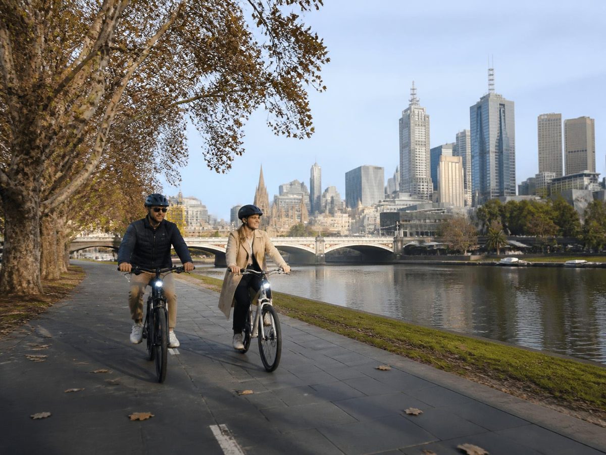Cyclists on a riverside path beside the Yarra in Melbourne.